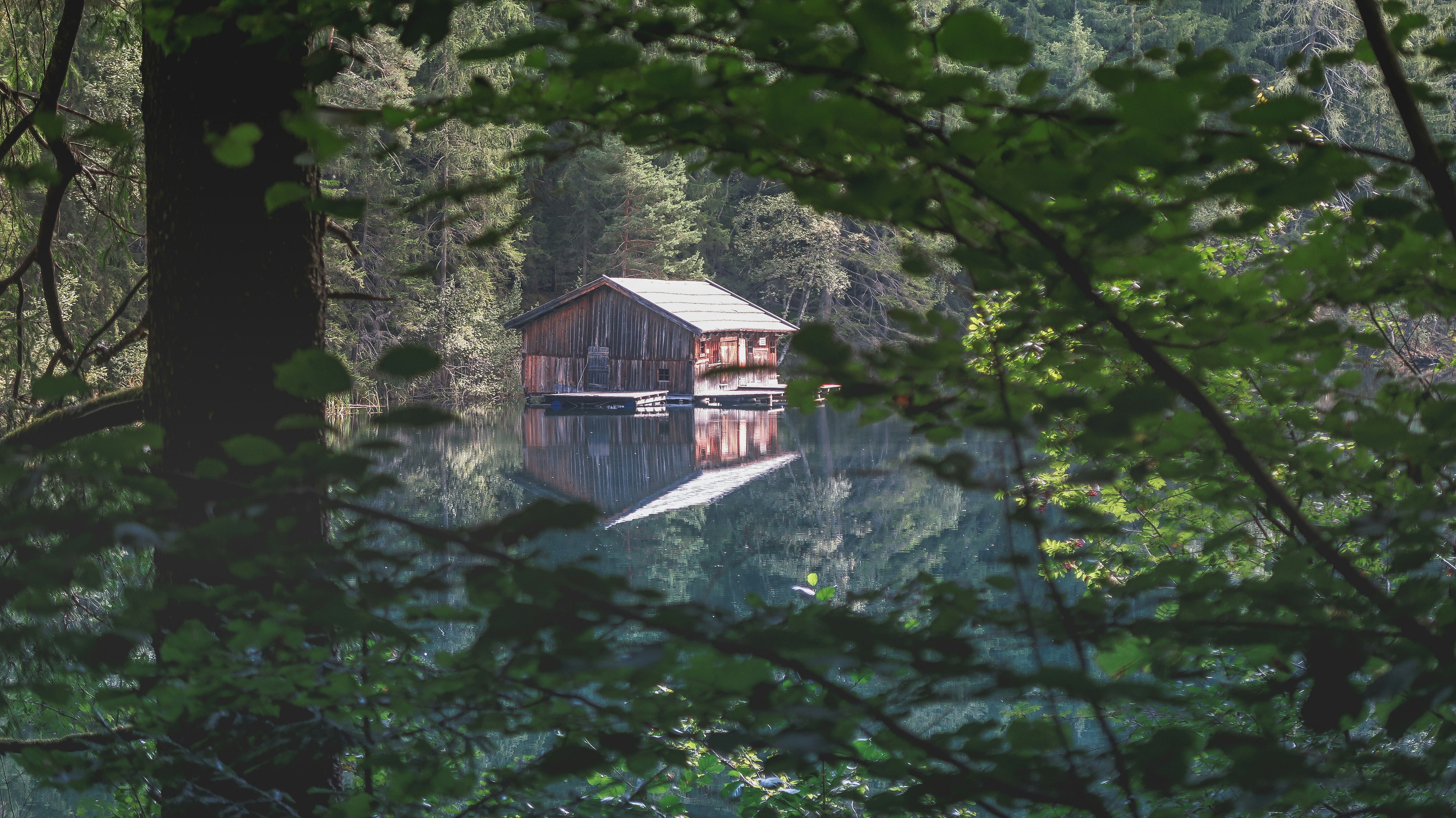 brown wooden house on river